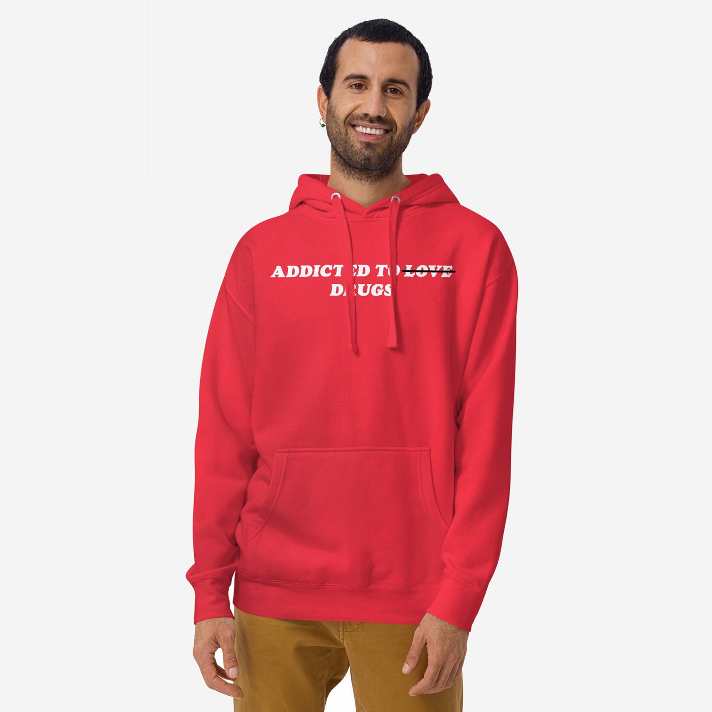 Man wearing Addicted To Love / Drugs hoodie with “LOVE” crossed out, symbolizing personal struggle and self-awareness. The bright red pullover features a front pocket and white drawstrings, reflecting bold, unapologetic expression.