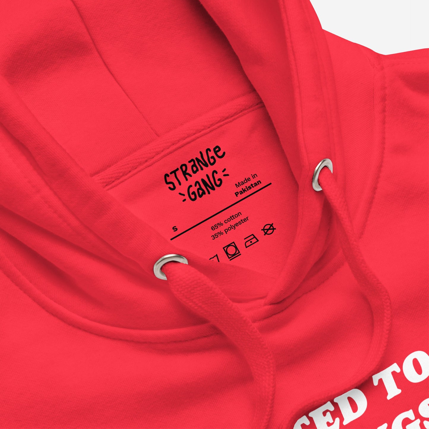 Close-up of the Addicted To Love / Drugs Hoodie, featuring STRANGE GANG label, size S, red drawstrings through metal grommets, and partial white graphic suggesting bold, thought-provoking design.