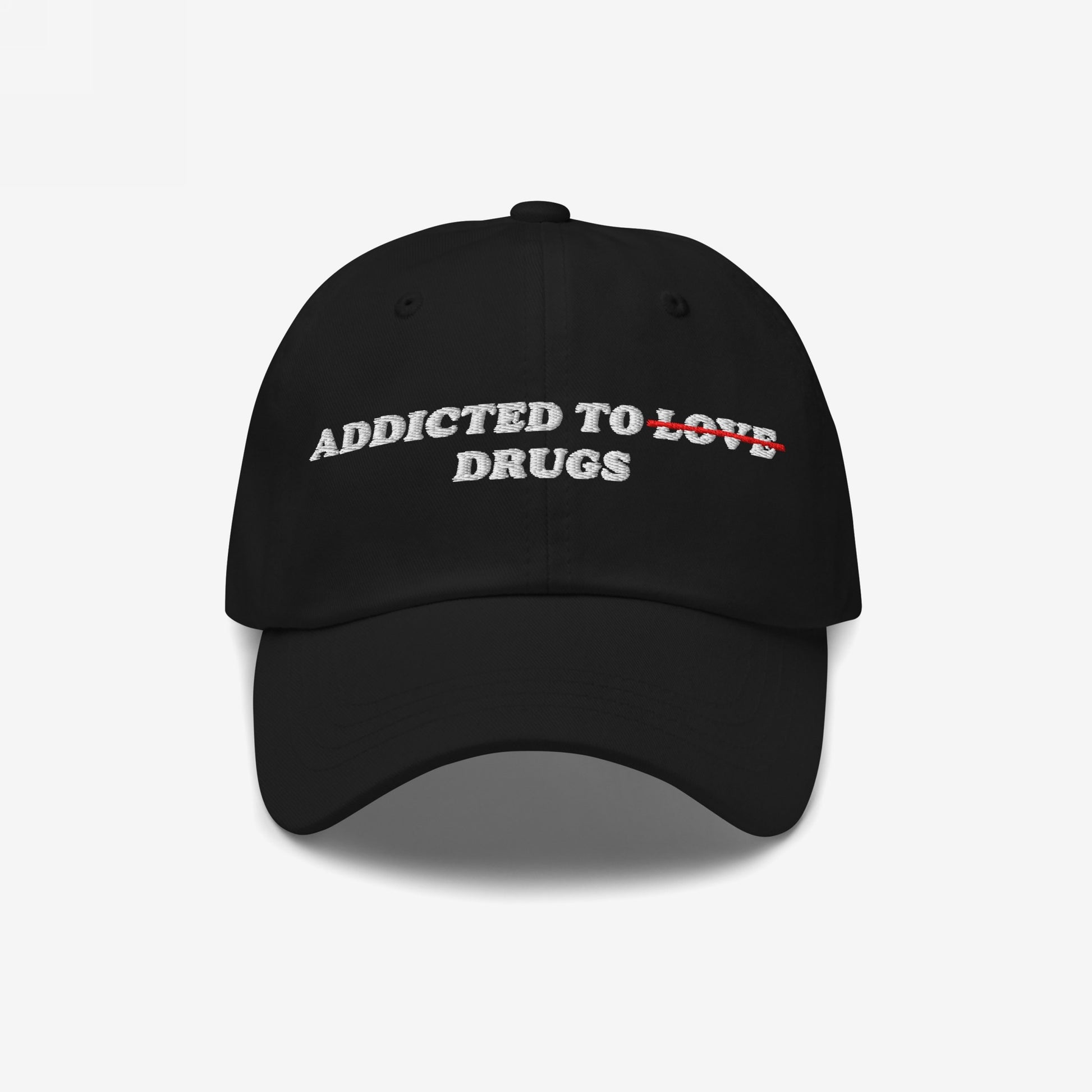 Black embroidered Addicted To Love / Drugs Hat with "Love" crossed out and replaced by "Drugs" in bold text on front.