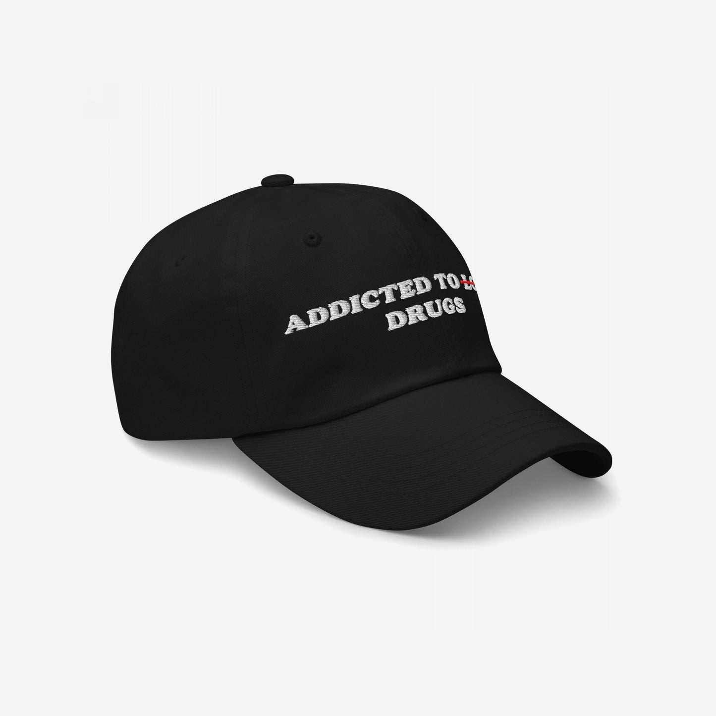 Addicted To Love / Drugs Hat: Black baseball cap with curved bill, featuring ADDICTED TO ~TO~ DRUGS in bold white embroidery, striking through TO in red, embodying raw honesty and edgy style.