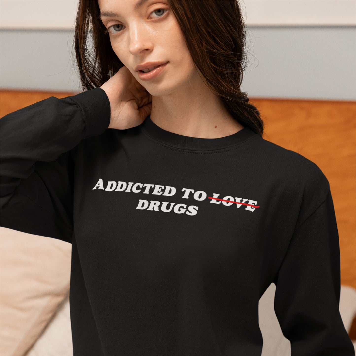 Young woman wearing the Addicted To Love / Drugs T-shirt with Love crossed out, highlighting a bold, ironic message. The design aligns with a stance for equality and expression.