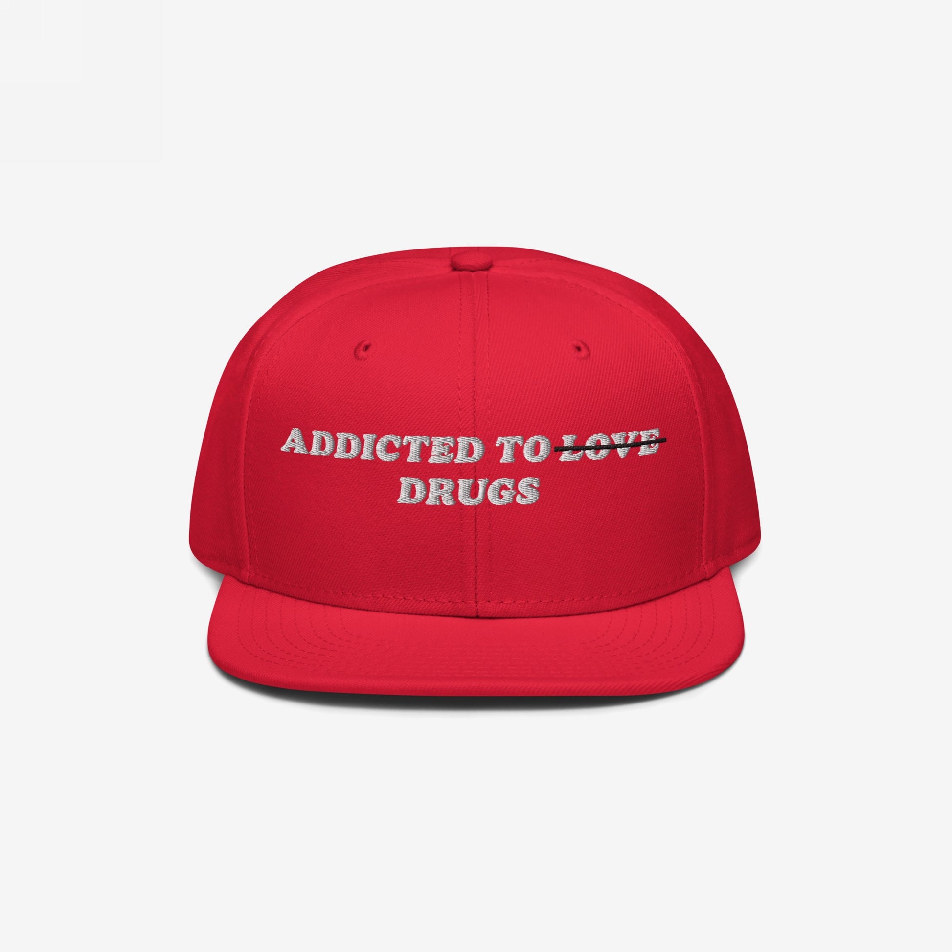 Red snapback hat with embroidered "Addicted To Love" crossed out and replaced by "Drugs" text, titled Addicted To Love / Drugs Hat.