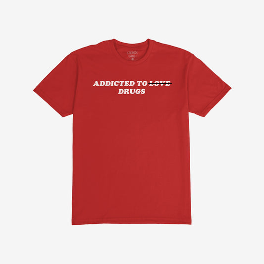 Addicted To Love / Drugs T-shirt: Bold red design with LOVE struck out, highlighting ADDICTED TO DRUGS in white letters, blending irony and edge. Available in men/unisex styles.