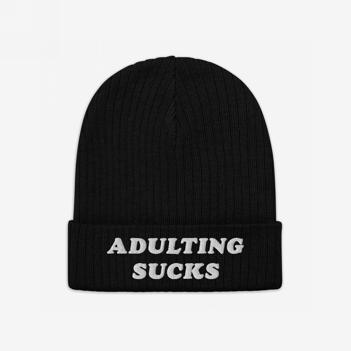 The Adulting Sucks Hat features a black knit beanie with a folded cuff, displaying “ADULTING SUCKS” in white embroidery, capturing a relatable message for those embracing life's challenges.