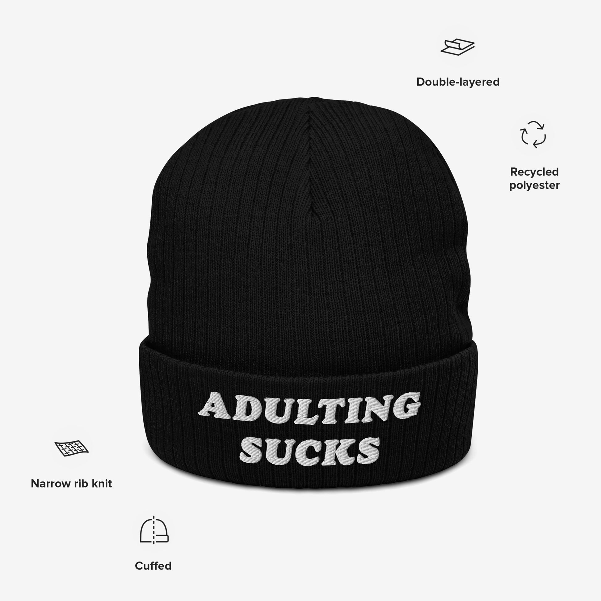 Black knit beanie with ADULTING SUCKS embroidered in white, featuring a cuffed, vintage-inspired design. Made from recycled polyester, it’s ideal for expressing relatable frustrations with adult responsibilities.