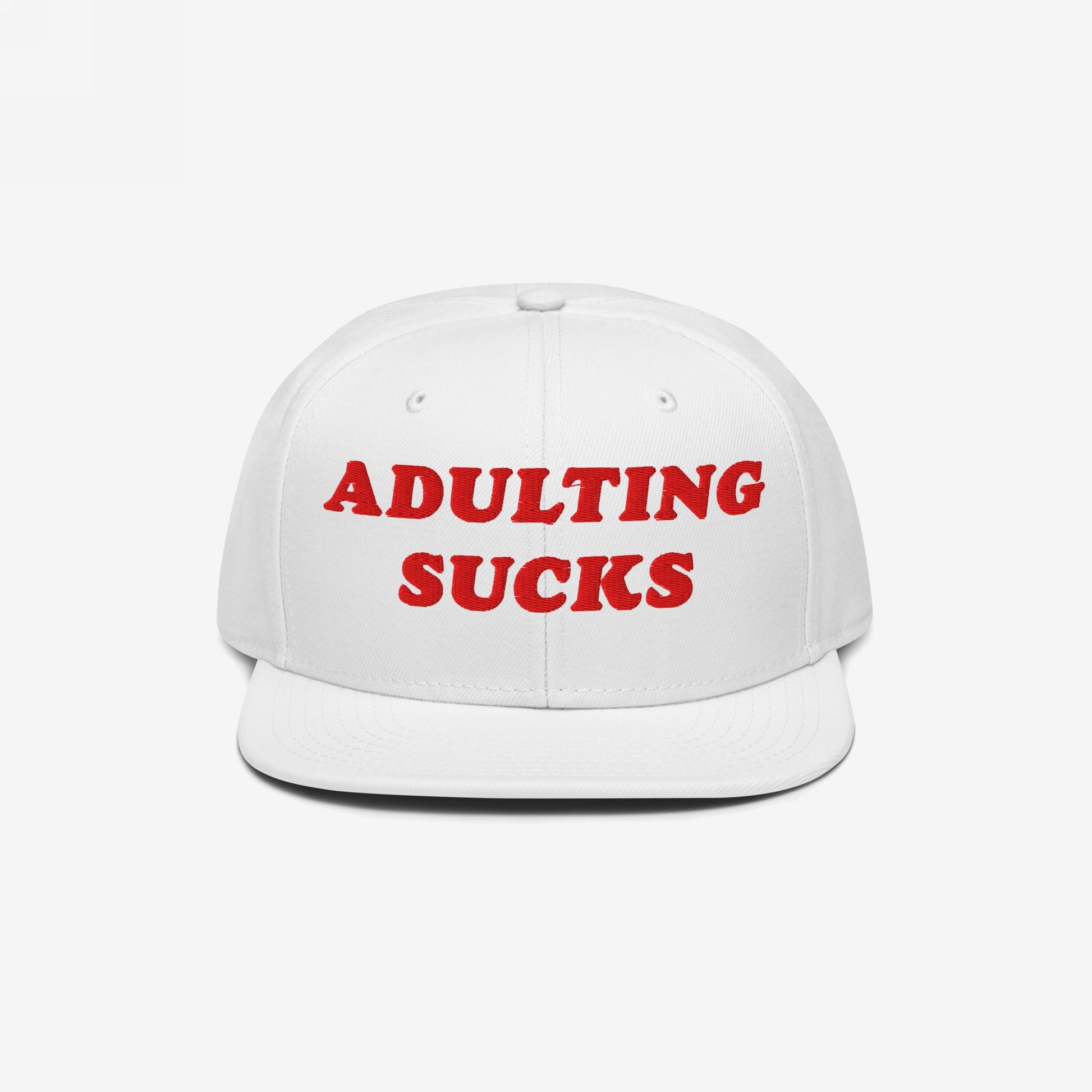 White flat-brim cap with bold red ADULTING SUCKS embroidery, reflecting a vintage-inspired, relatable style for expressing frustration with adult responsibilities. Perfect for casual wear or as a humorous gift.