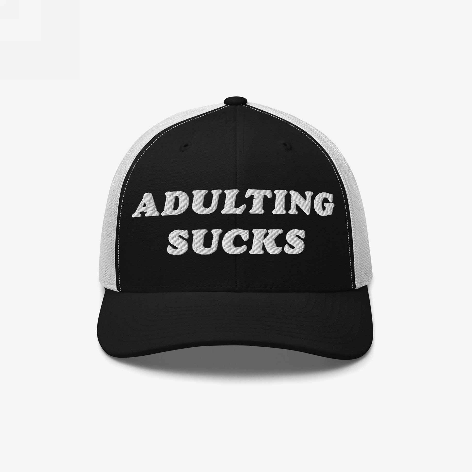 Black-and-white trucker hat with ADULTING SUCKS embroidered on front. Features white mesh panels, curved black bill. Ideal for expressing modern life's frustrations. Supports NAMI with each purchase.