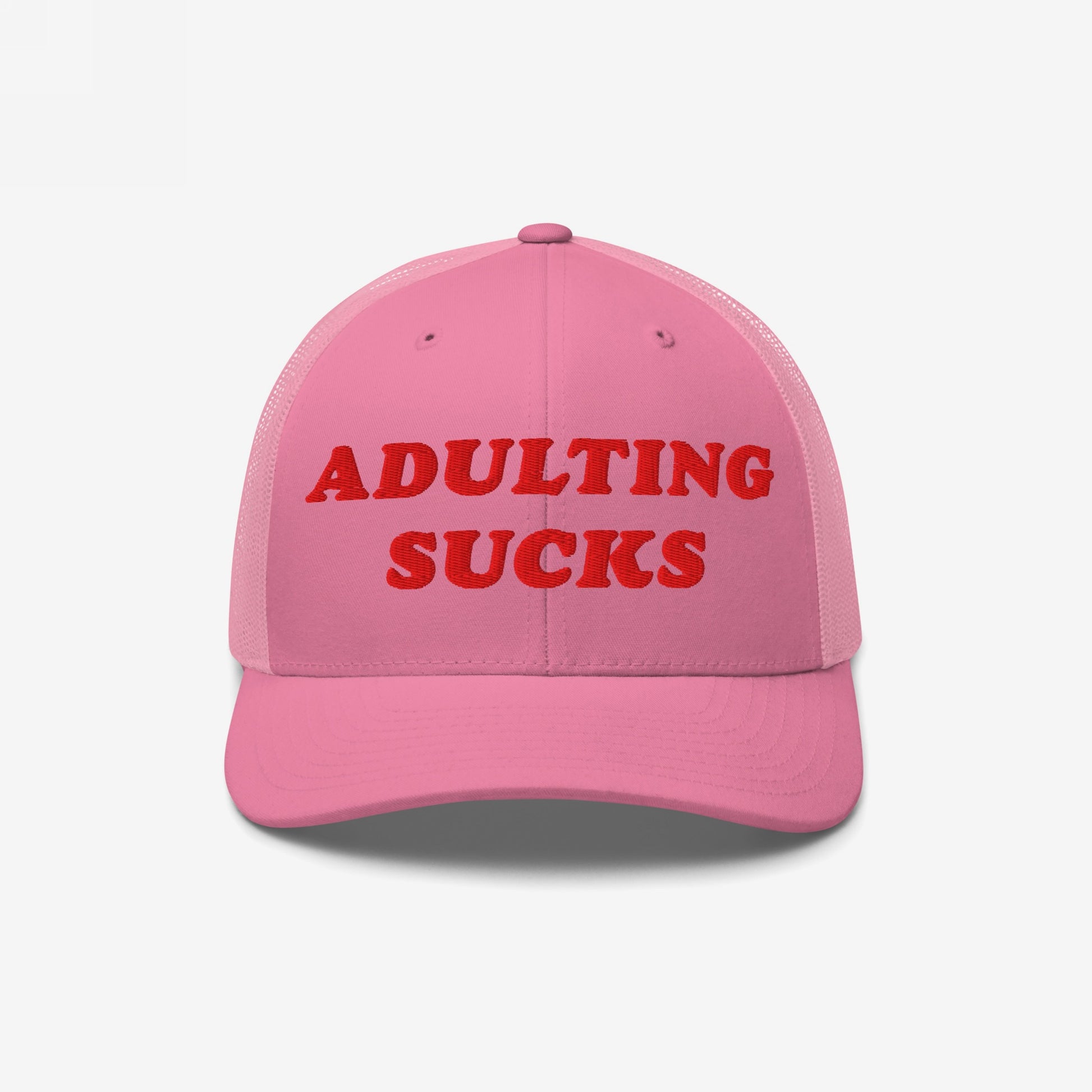 The Adulting Sucks Hat features bold red embroidery on a pink trucker-style cap, encapsulating the struggle against adult responsibilities with a vintage flair, ideal for expressing relatable frustration.