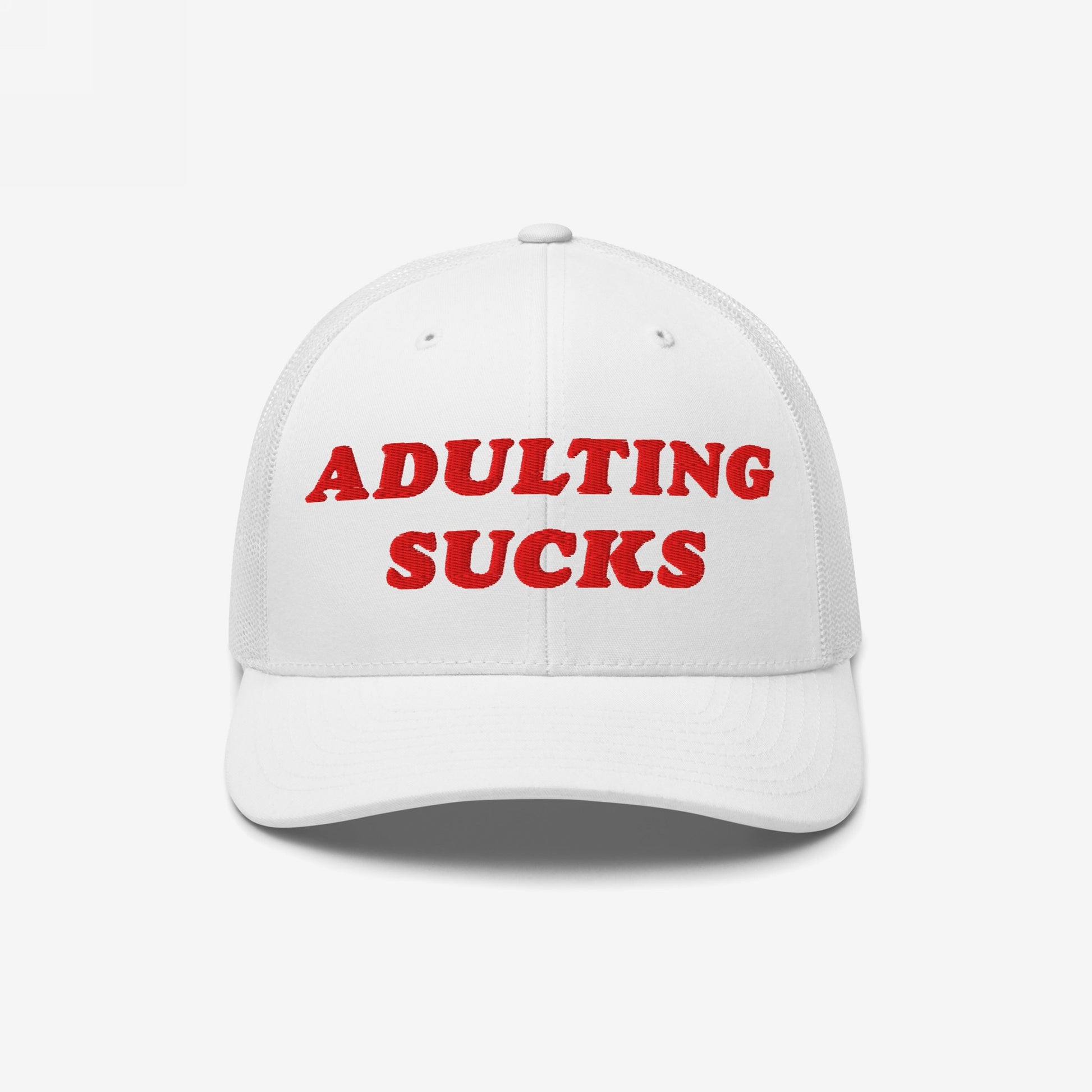 White mesh-back trucker hat with bold red embroidery stating “ADULTING SUCKS,” capturing a candid sentiment for millennials and Gen Z, perfect for casual wear and expressing honest frustration.