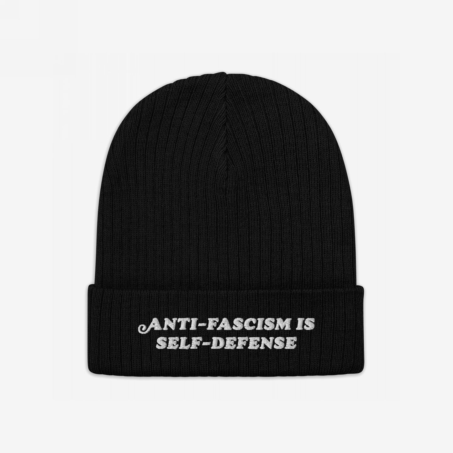 Black knitted beanie featuring the slogan “ANTI-FASCISM IS SELF-DEFENSE” embroidered on the cuff, embodying a bold statement against injustice.
