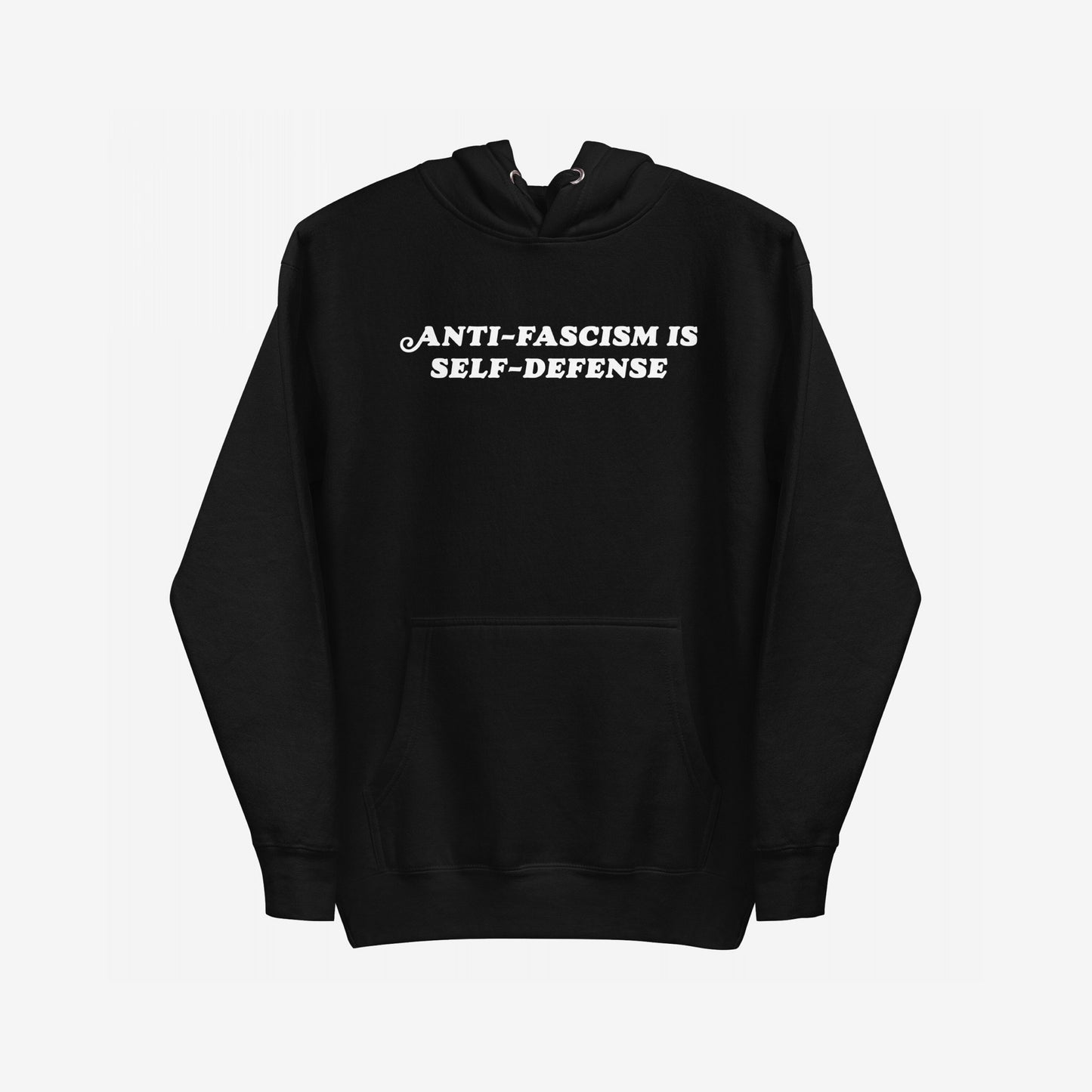 Black pullover Anti-Fascism Is Self-Defense Hoodie with a kangaroo pocket, featuring bold white text on the chest. Designed for those who stand against hate, it combines retro style with a powerful message.