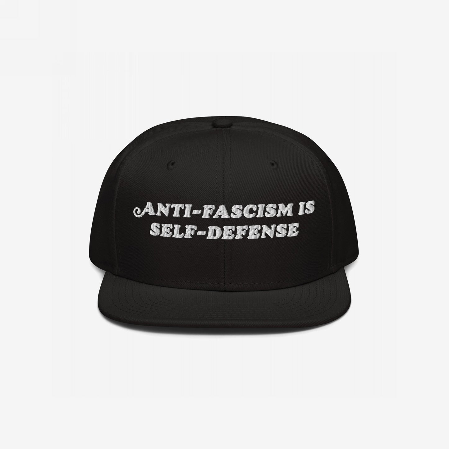 Black flat-brimmed snapback hat, “Anti-Fascism Is Self-Defense” embroidered boldly in white. A statement piece for those who resist.