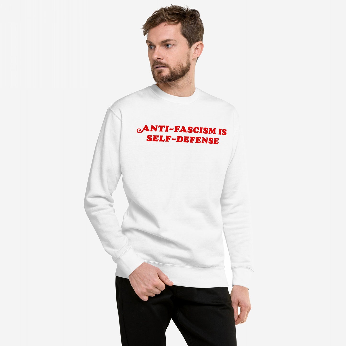 Model wearing Anti-Fascism Is Self-Defense Hoodie & Sweatshirt with bold red slogan, embodying a message of resistance and equality, standing against a plain backdrop.