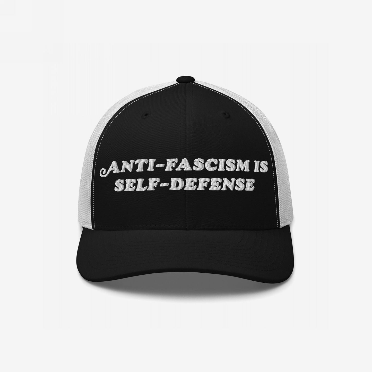 Anti-Fascism Is Self-Defense Hat: Black-and-white trucker cap with bold white embroidery, advocating anti-fascism as self-defense. Ideal for those who wear activism proudly, supporting equality and resistance.