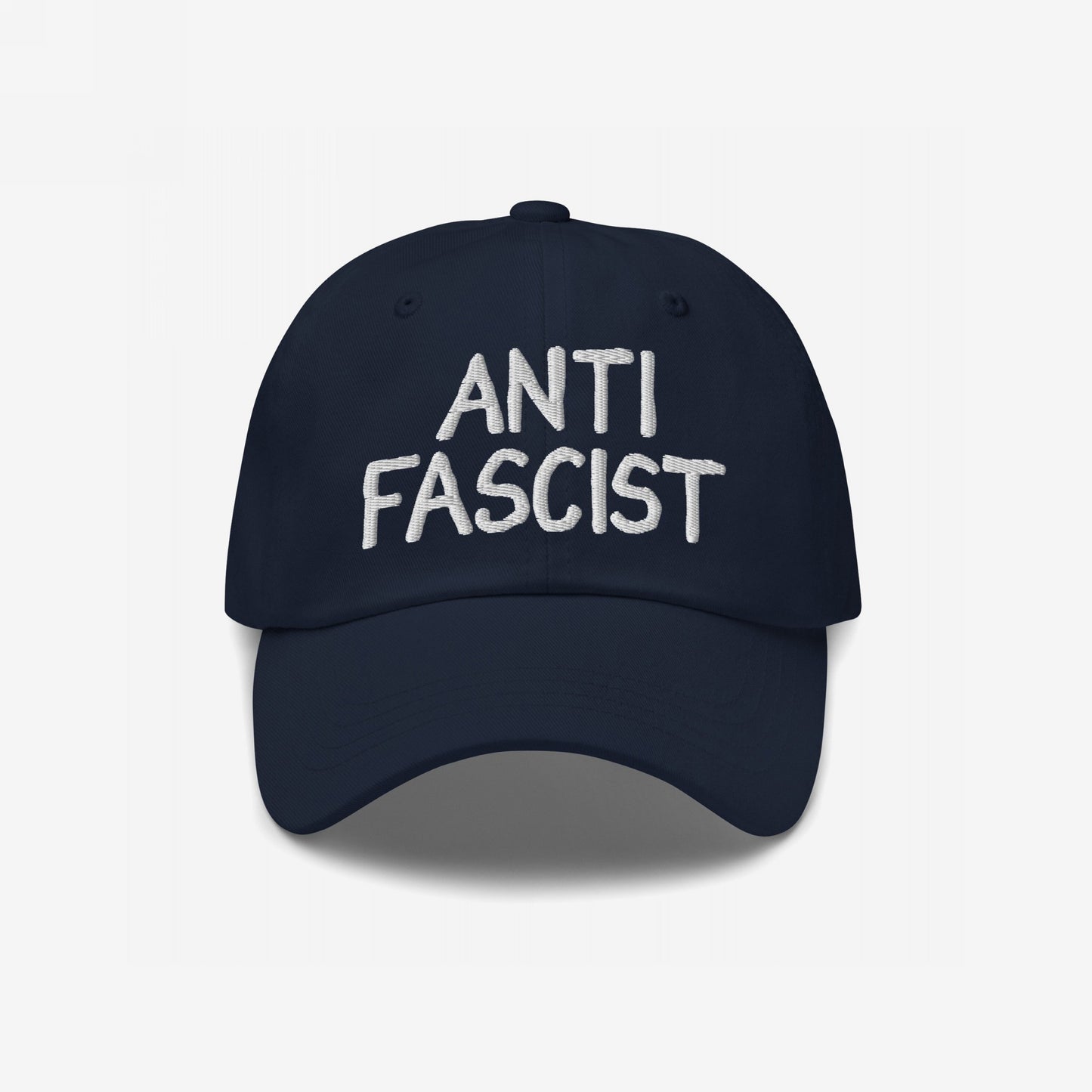 Anti-Fascist Hat with white embroidered text, featuring a soft, navy baseball-style design. This ethically made cap symbolizes resistance, offering a stylish way to express anti-fascist values daily.