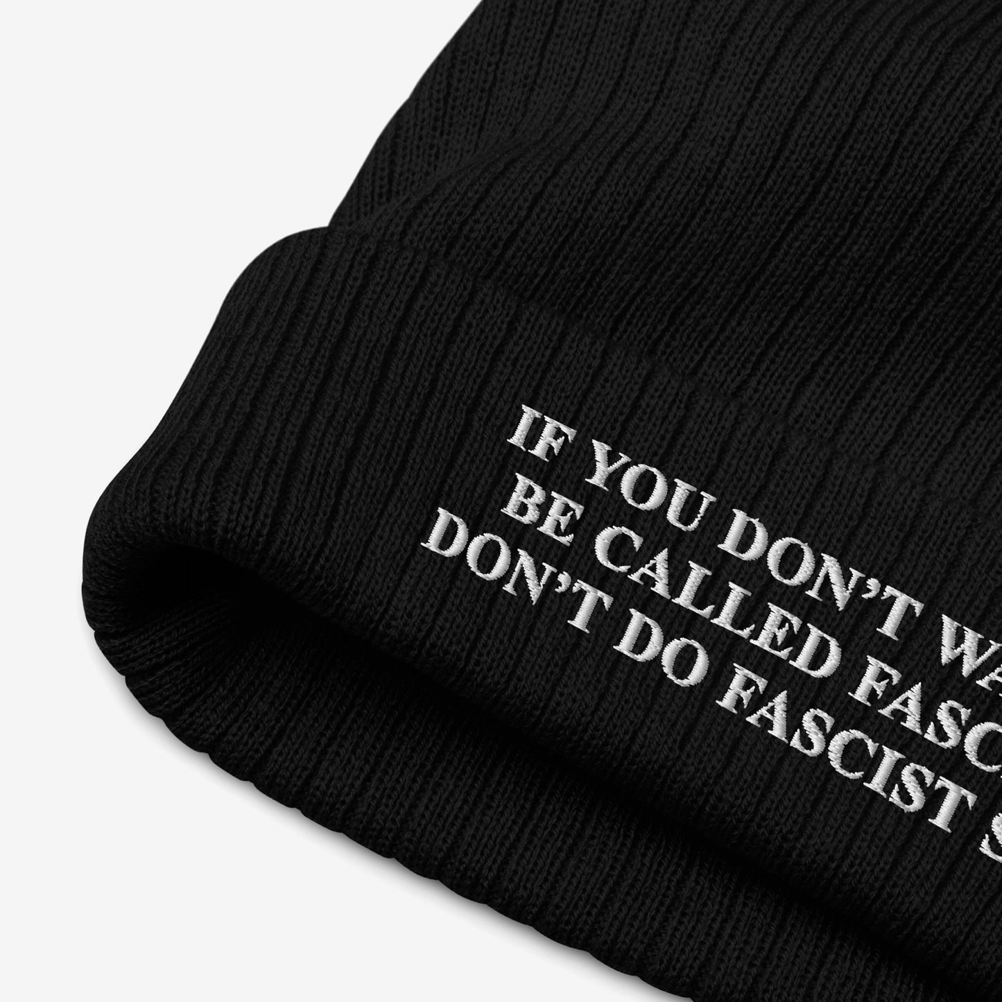 Black rib-knit beanie hat titled Anti-Fascist Retro Hat with bold white embroidered message: If you don’t want to be called fascist, don’t do fascist shit, embodying resistance and activism.