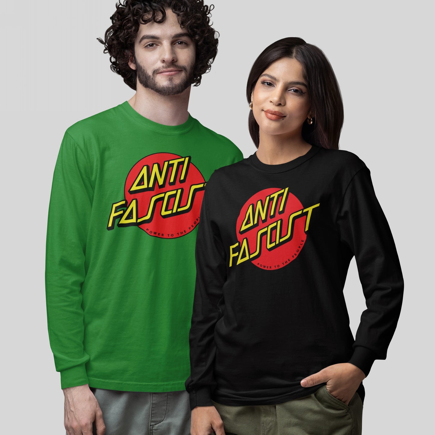 Two models wearing Anti-Fascist T-shirts with a red circle and “ANTI FASCIST” in yellow font, embodying activism and resistance. The design includes “POWER TO THE PEOPLE” in bold beneath the circle.