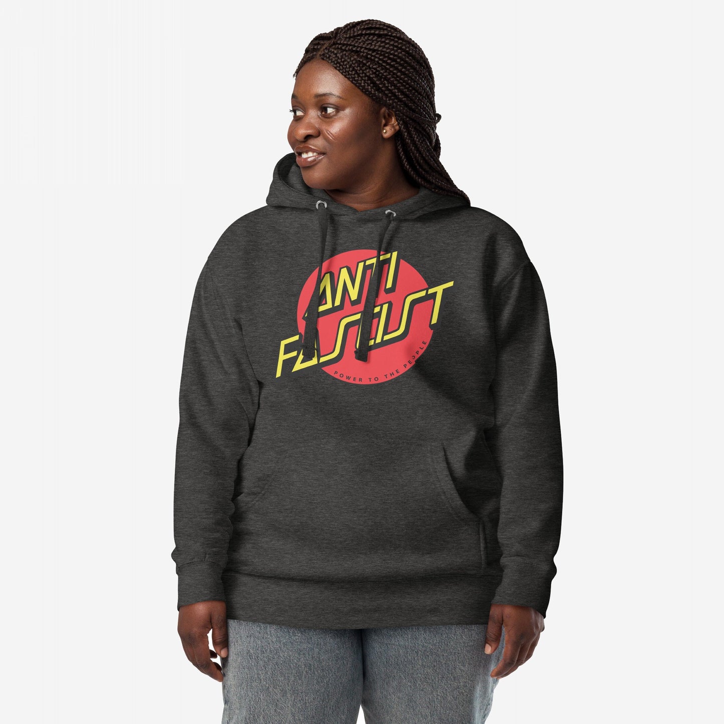 Anti-Fascist Hoodie & Sweatshirt featuring a bold ANTI FASCIST logo in yellow and red, worn by a person with braided hair, reflecting a street-punk style and political message.