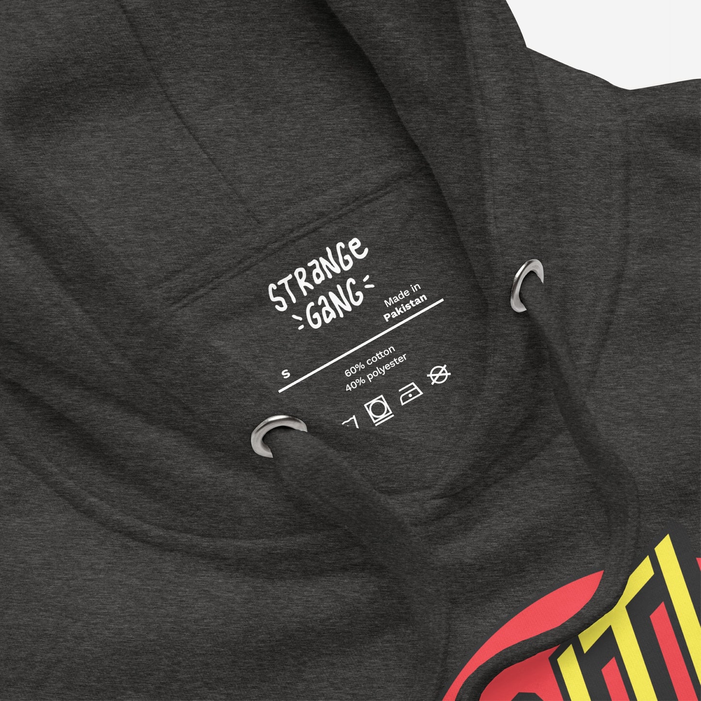Anti-Fascist Hoodie & Sweatshirt label close-up, showing size S, fabric composition, laundry care symbols, and metal eyelets, with a glimpse of the impactful red/yellow graphic promoting anti-fascist values.