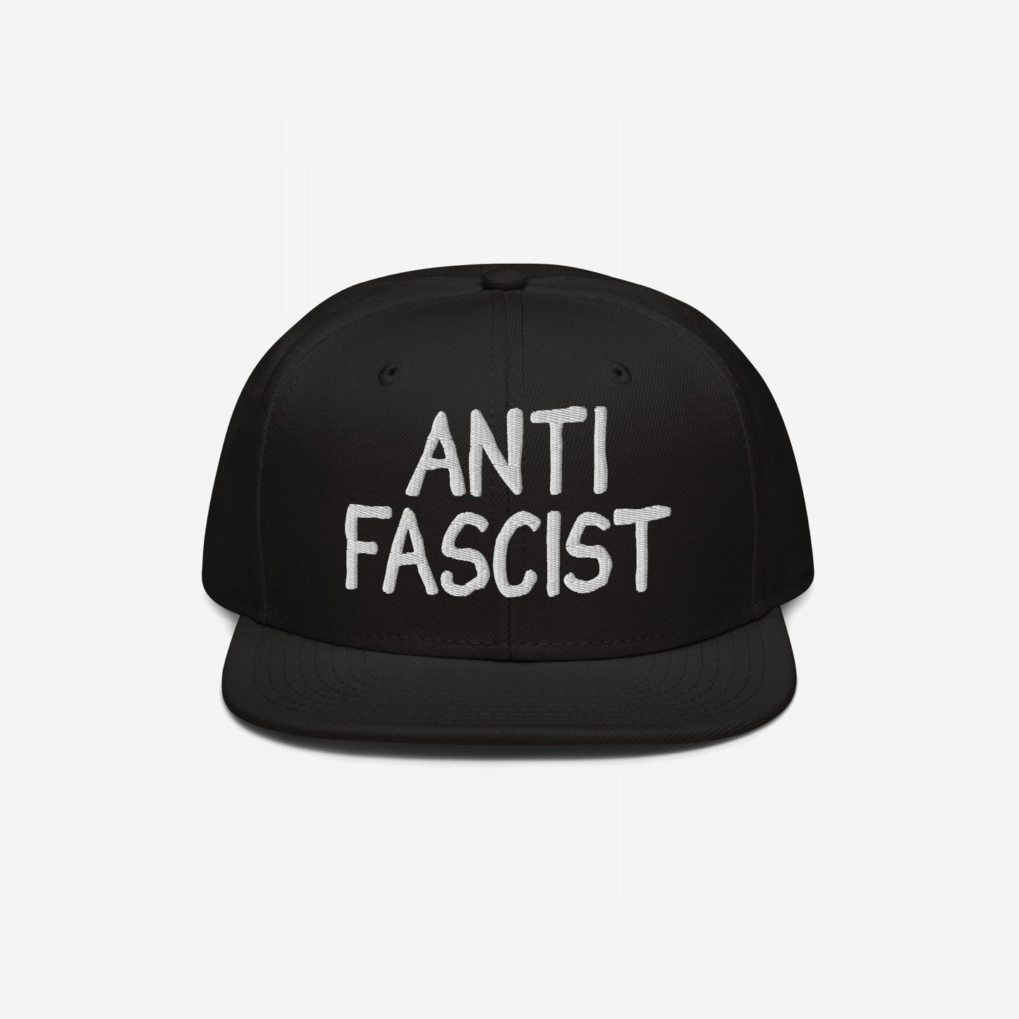 Anti-Fascist Hat: A black flat-brim cap featuring ANTI FASCIST in bold white embroidery. Ethically made and gender-free, it serves as a stylish statement against fascism.