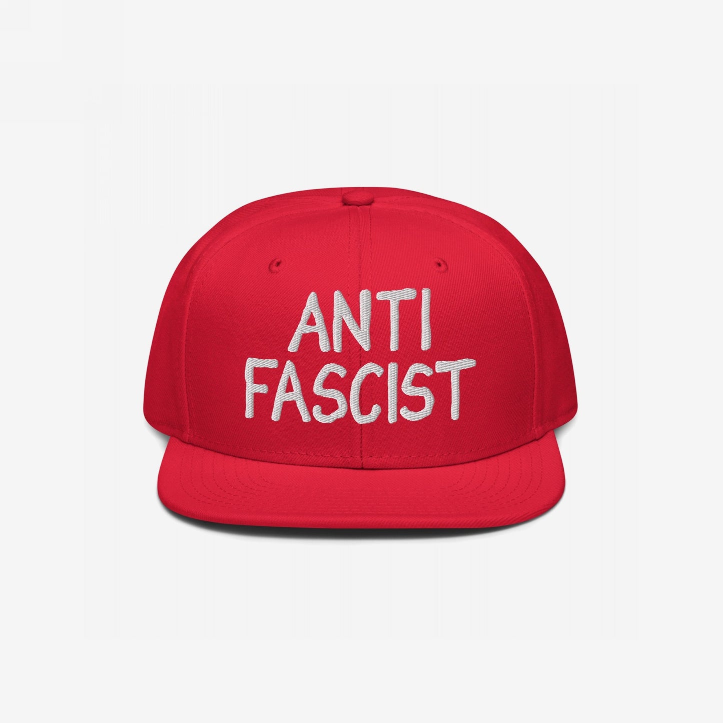 Red snapback with ANTI FASCIST in white embroidery, embodying a protest spirit. Ethically made, gender-free, and stylishly defiant, aligning with the ethos of equality and opposition to fascism.