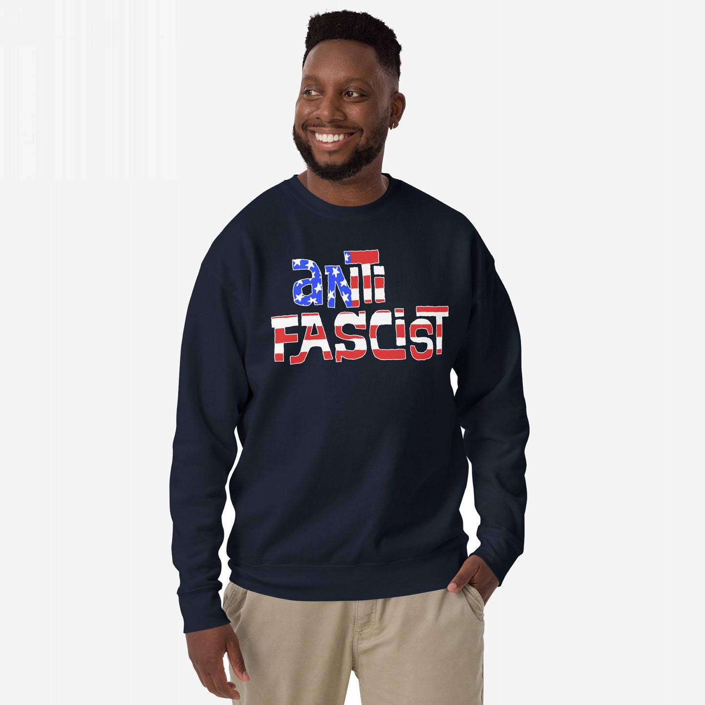 Man wearing Anti-Fascist USA Hoodie & Sweatshirt with a bold “ANTI FASCIST” print in a flag-inspired design, standing confidently against a neutral background, embodying resistance and reclaiming patriotism.