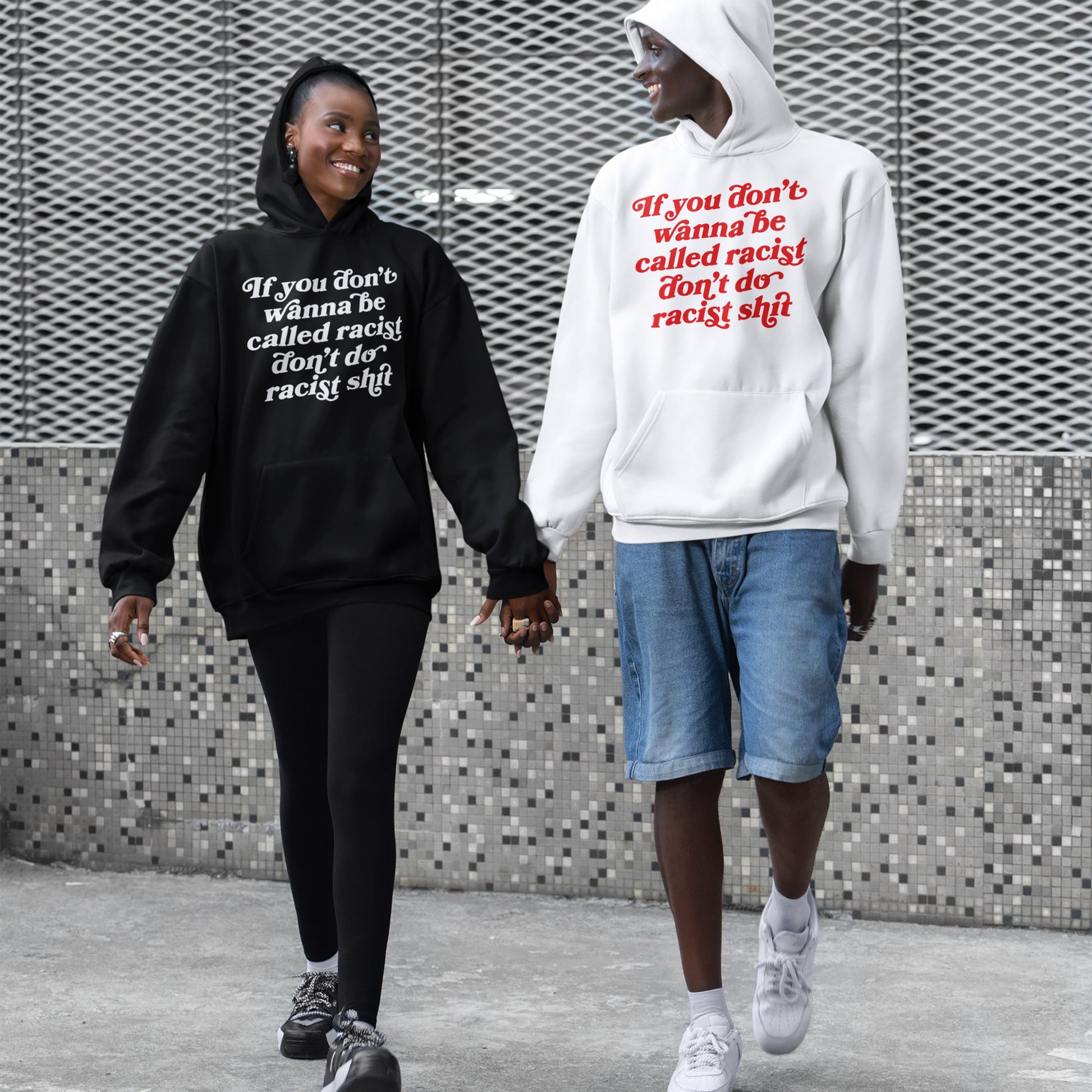 Anti-Racist Hoodie & Sweatshirt EU shown worn by two people holding hands, featuring the bold message: “If you don’t wanna be called racist don’t do racist shit,” highlighting a call for equality and awareness.