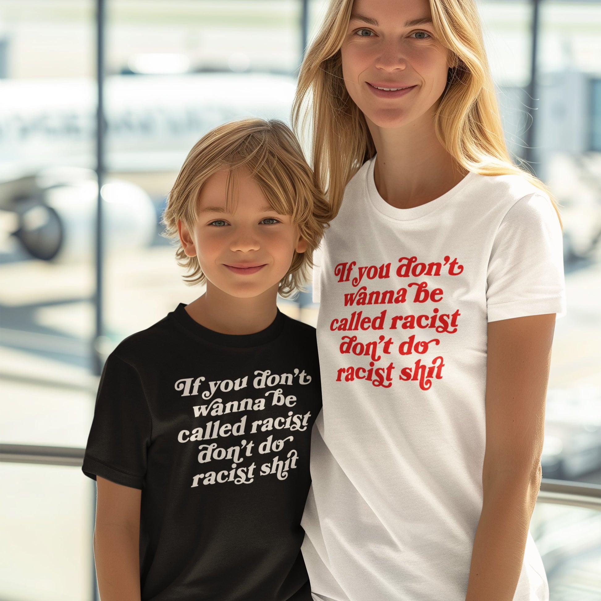 Woman and young boy in an indoor setting wearing Anti-Racist Shirts stating, “If you don’t wanna be called racist don’t do racist shit,” embodying a bold, unapologetic message against racism.