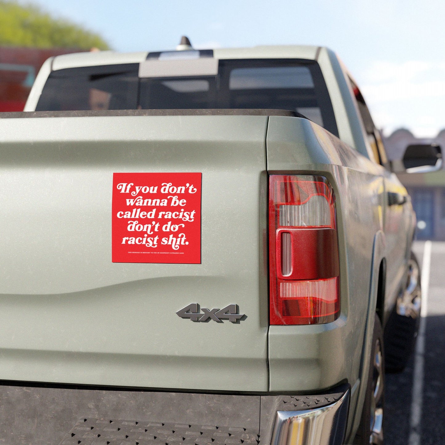 Anti-Racist Sticker & Magnet on a light green 4×4 pickup tailgate, boldly displaying the message against racism in red-and-white, aligned with the store's advocacy for equality and justice.