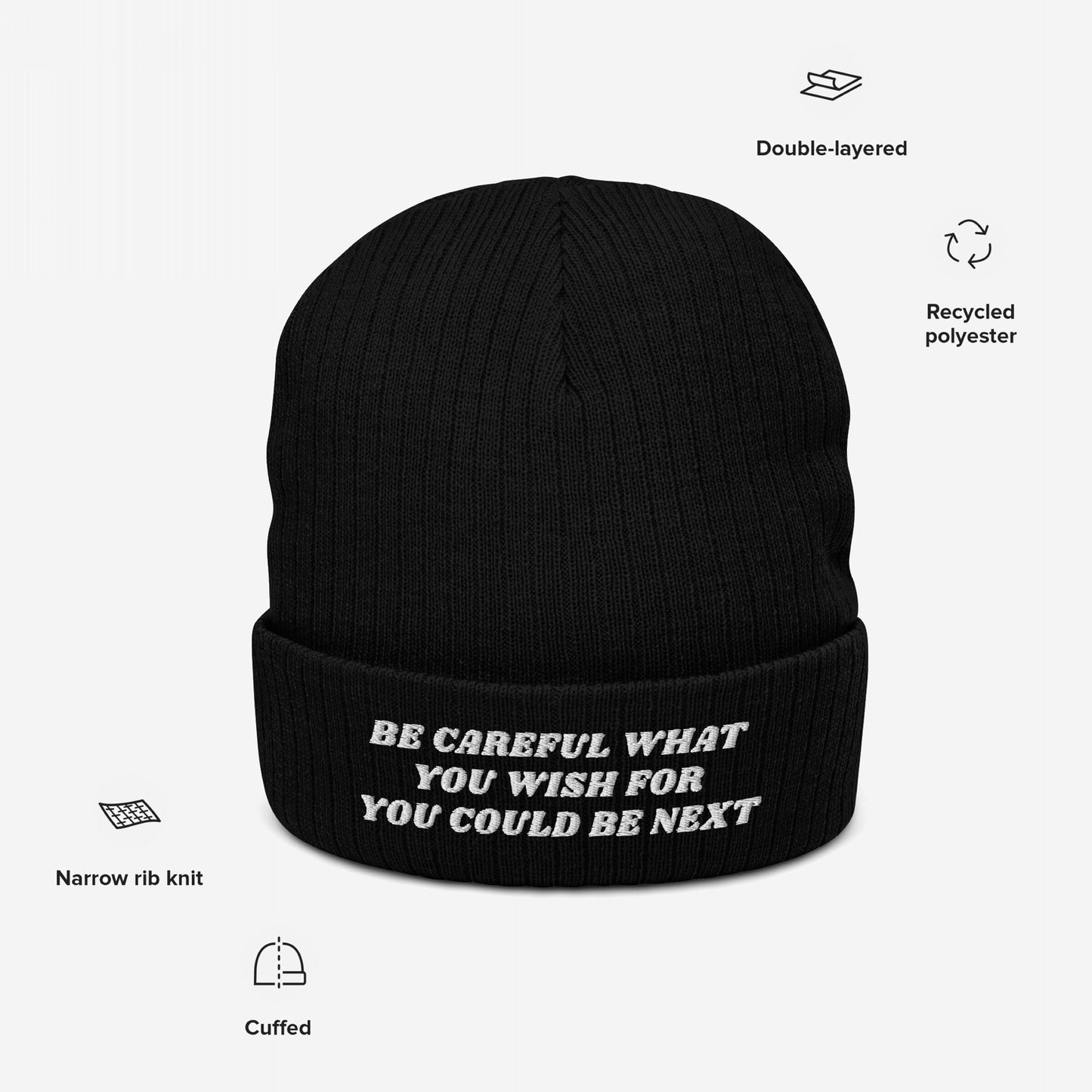 The Be Careful Hat features bold white embroidery on a black knit beanie, delivering a strong, silent message. Crafted from recycled polyester, it embodies a stylish yet purposeful statement.