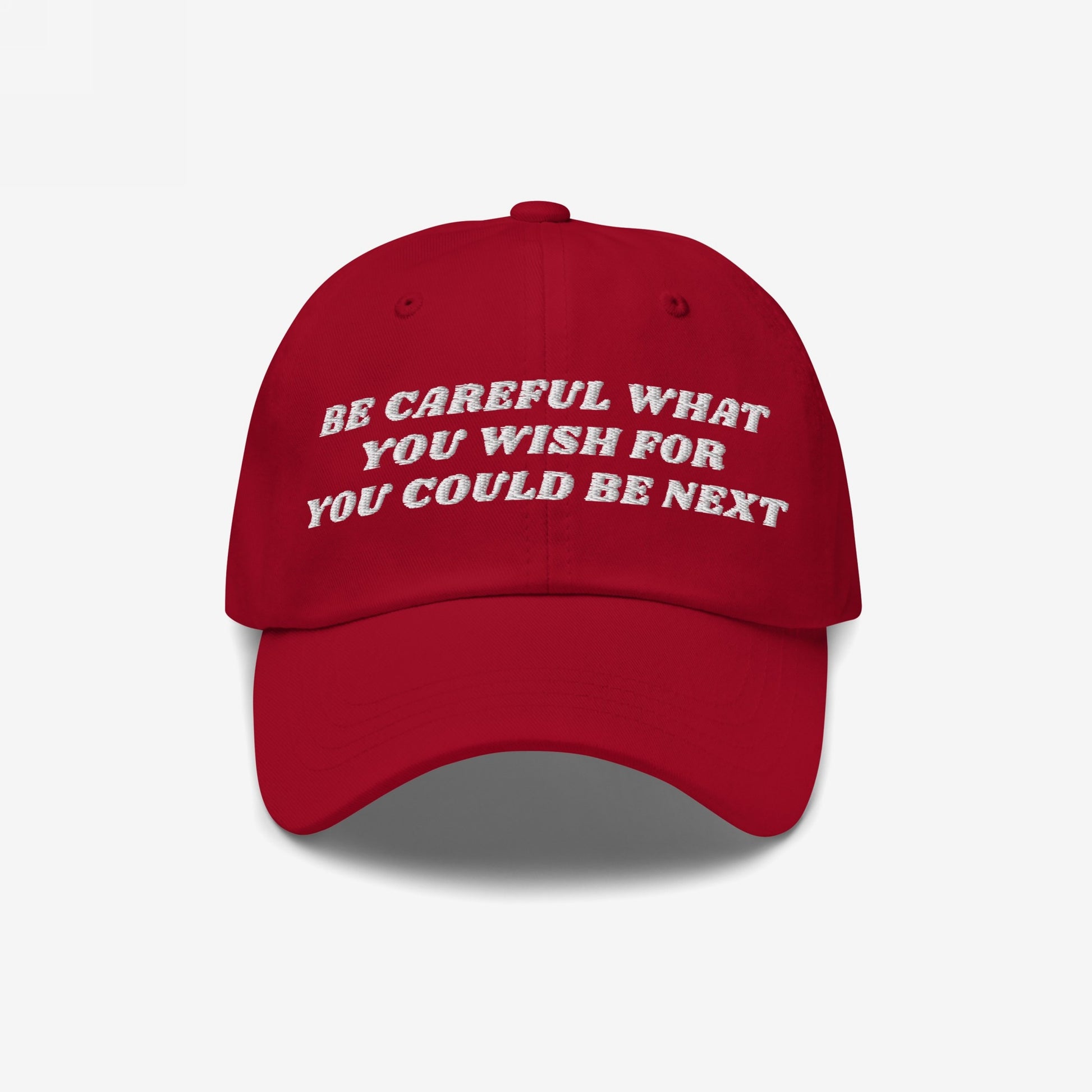 Red six-panel baseball cap featuring the bold phrase “BE CAREFUL WHAT YOU WISH FOR YOU COULD BE NEXT,” embodying a progressive political statement. Ideal for activists supporting justice and equality.