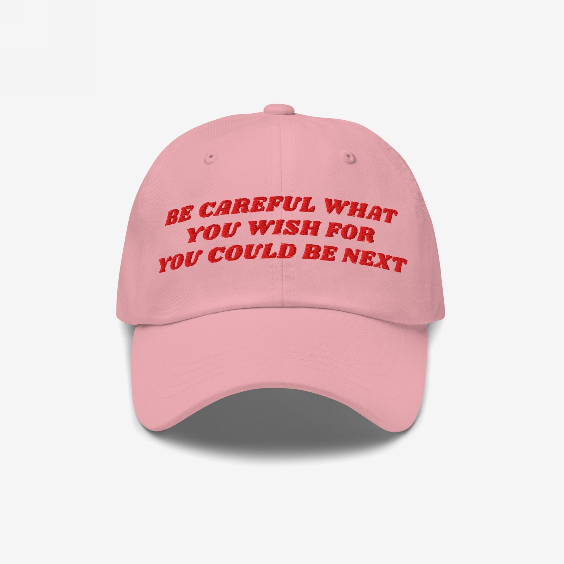 The Be Careful Hat features bold red embroidery stating, Be careful what you wish for – you could be next, symbolizing a stand against fascism and support for equality.