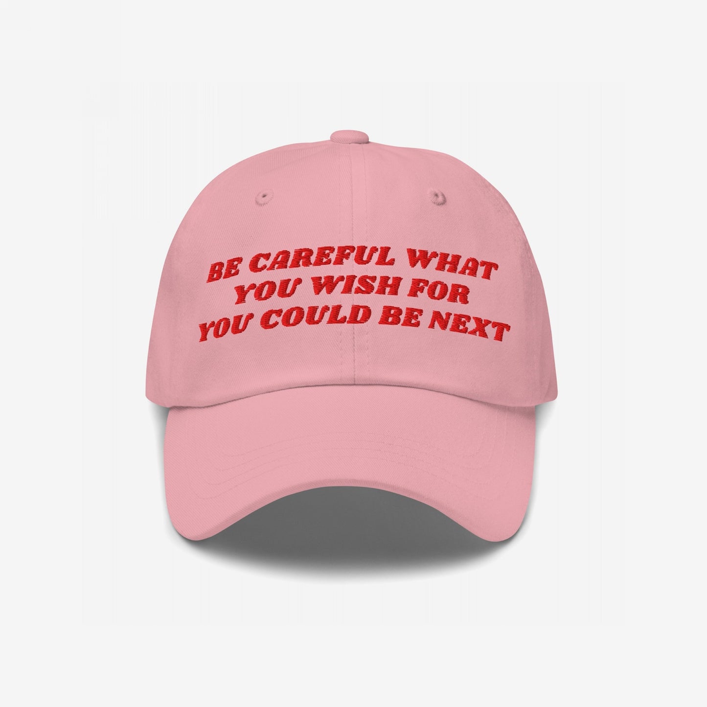 Pink 'Be Careful Hat' with bold red embroidery reads “BE CAREFUL WHAT YOU WISH FOR YOU COULD BE NEXT.” A stylish statement accessory supporting equality and activism.
