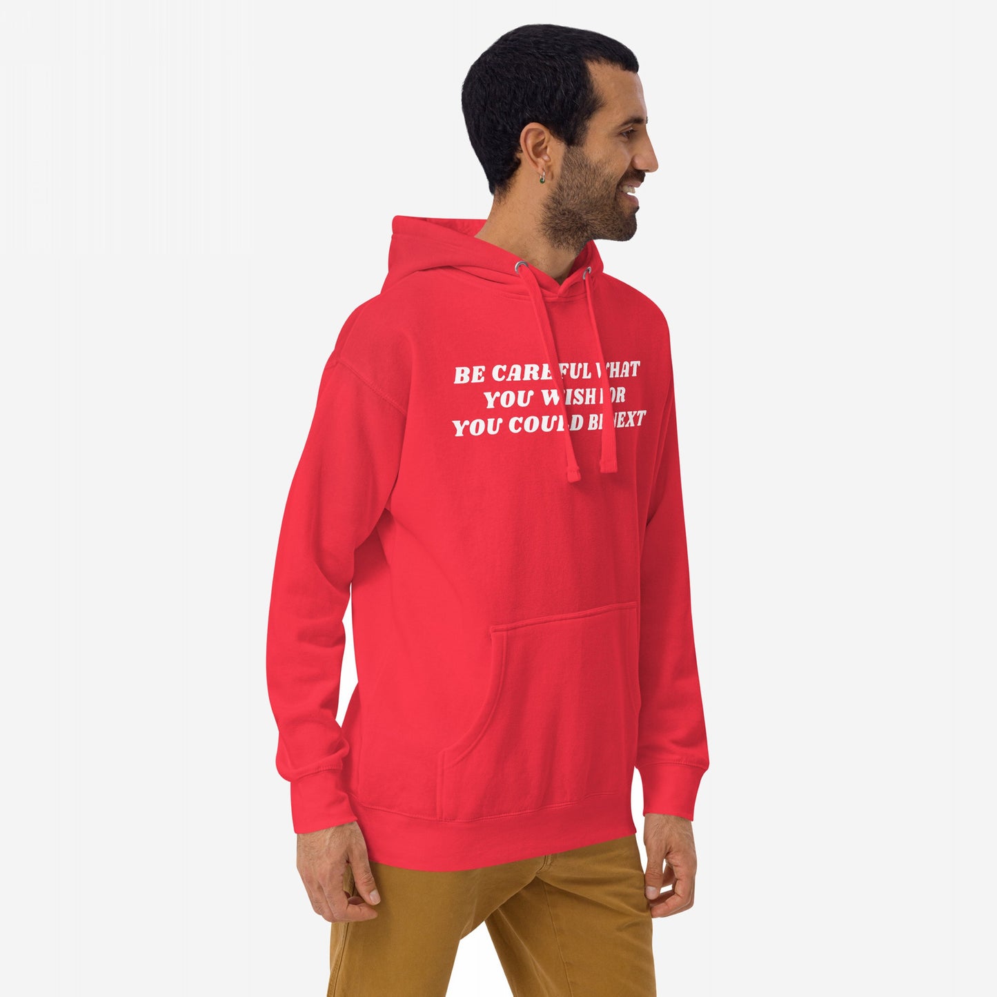 Man wearing Be Careful Hoodie & Sweatshirt with distressed bold text, embodying a rebellious spirit against authoritarianism. The red hoodie features a kangaroo pocket, drawstrings, and a thought-provoking message.