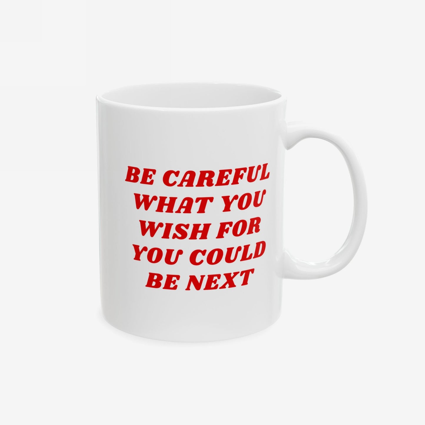 The Be Careful Mug features bold red text warning BE CAREFUL WHAT YOU WISH FOR YOU COULD BE NEXT on a white ceramic surface, embodying a strong message for progressive thinkers.