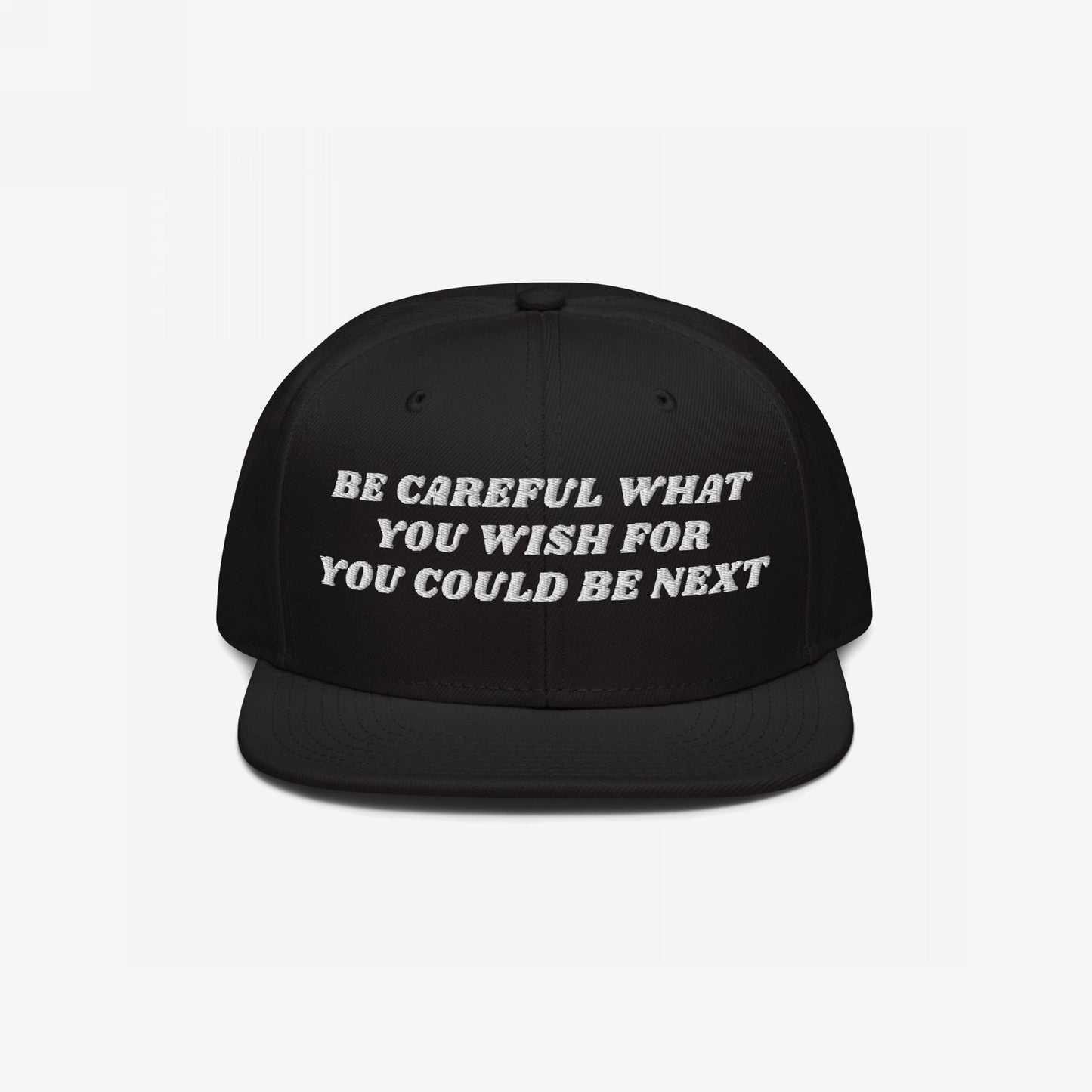 Black flat-brim snapback hat with white embroidered text: Be Careful What You Wish For - You Could Be Next. This Be Careful Hat delivers a bold message, merging style with activism.