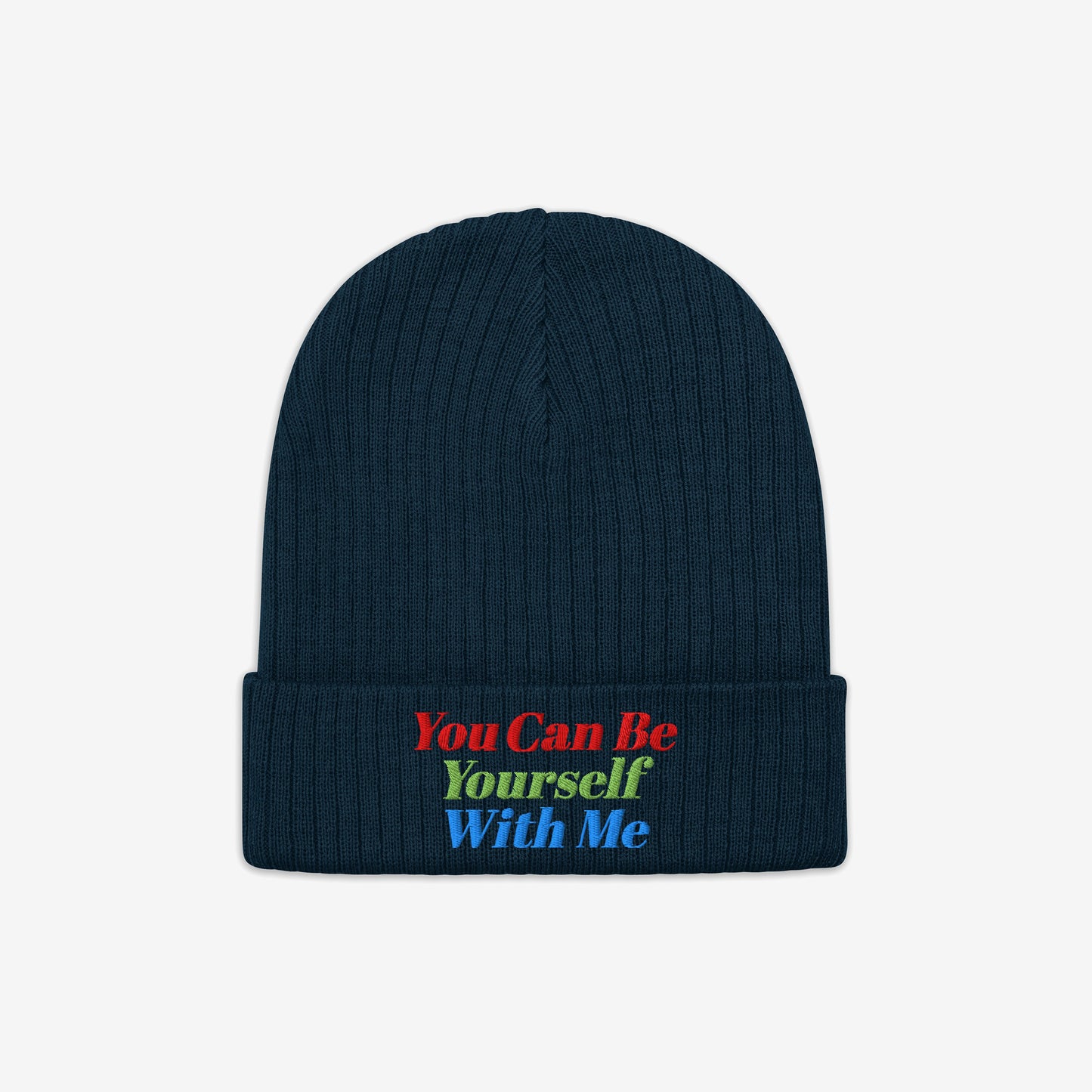 The Be Yourself Hat is a dark navy-blue, rib-knit beanie with a folded cuff, featuring the uplifting slogan You Can Be Yourself With Me embroidered across the front in vibrant colors.