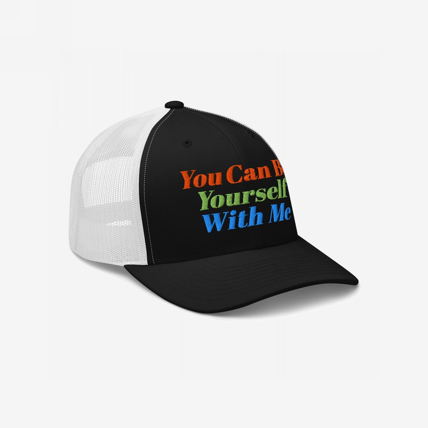 Black and white trucker hat with colorful embroidered text "You Can Be Yourself With Me," Be Yourself Hat promoting acceptance and individuality.