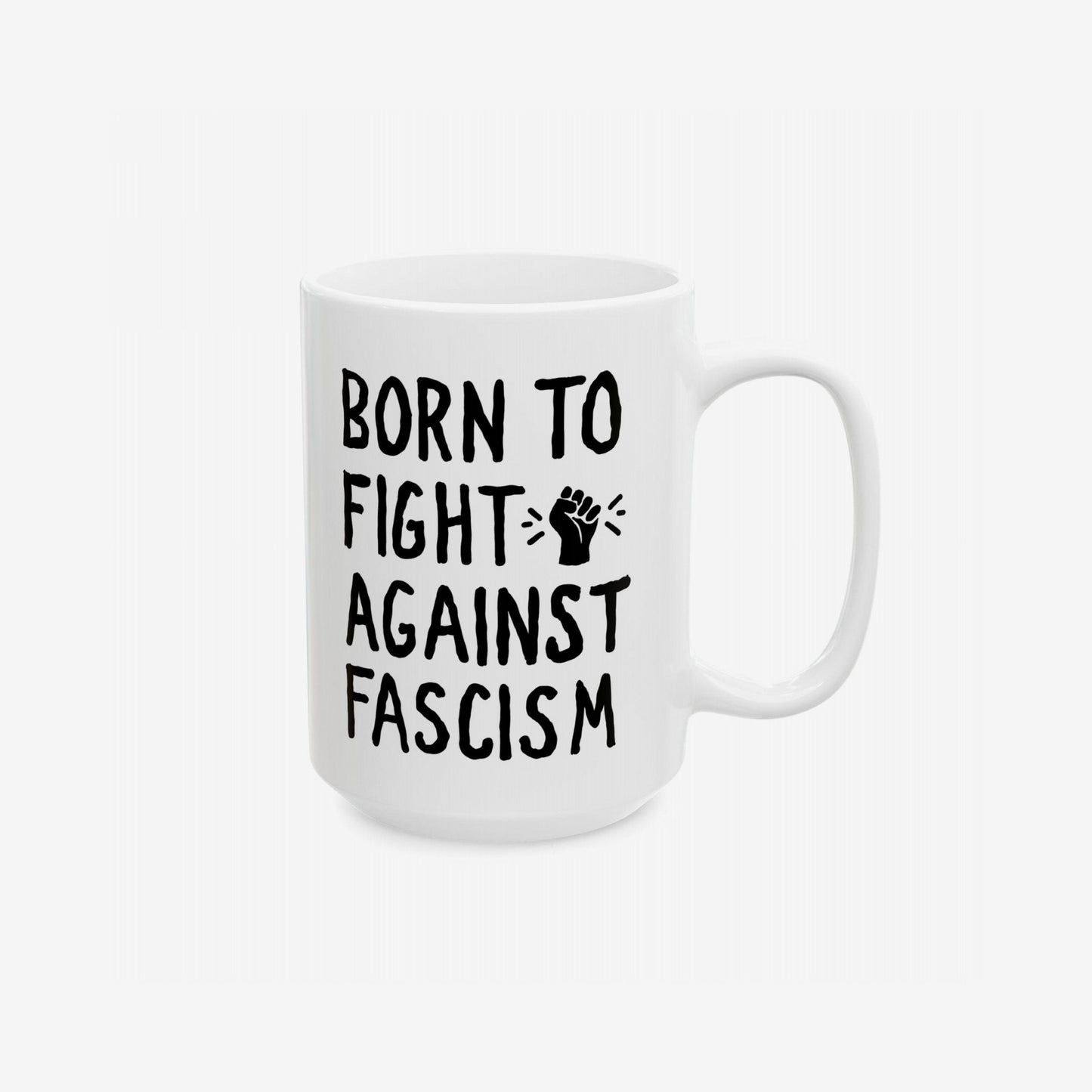 Born To Fight Against Fascism Mug featuring a bold slogan with a raised-fist icon, designed in black on white ceramic, embodies activism and resilience against fascism. Ideal for progressive, change-driven coffee moments.