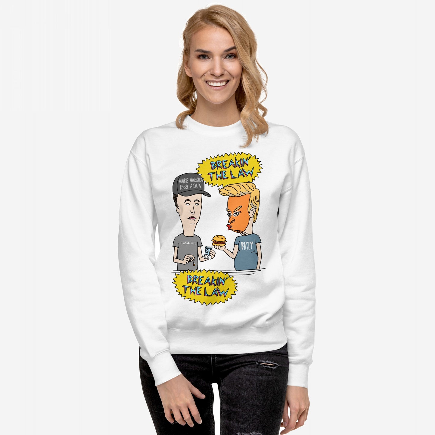 Breakin' The Law Sweatshirt features a parody cartoon of Trump with a burger and Musk holding a packet, styled like Beavis and Butt-Head, highlighting an anti-elitist message.