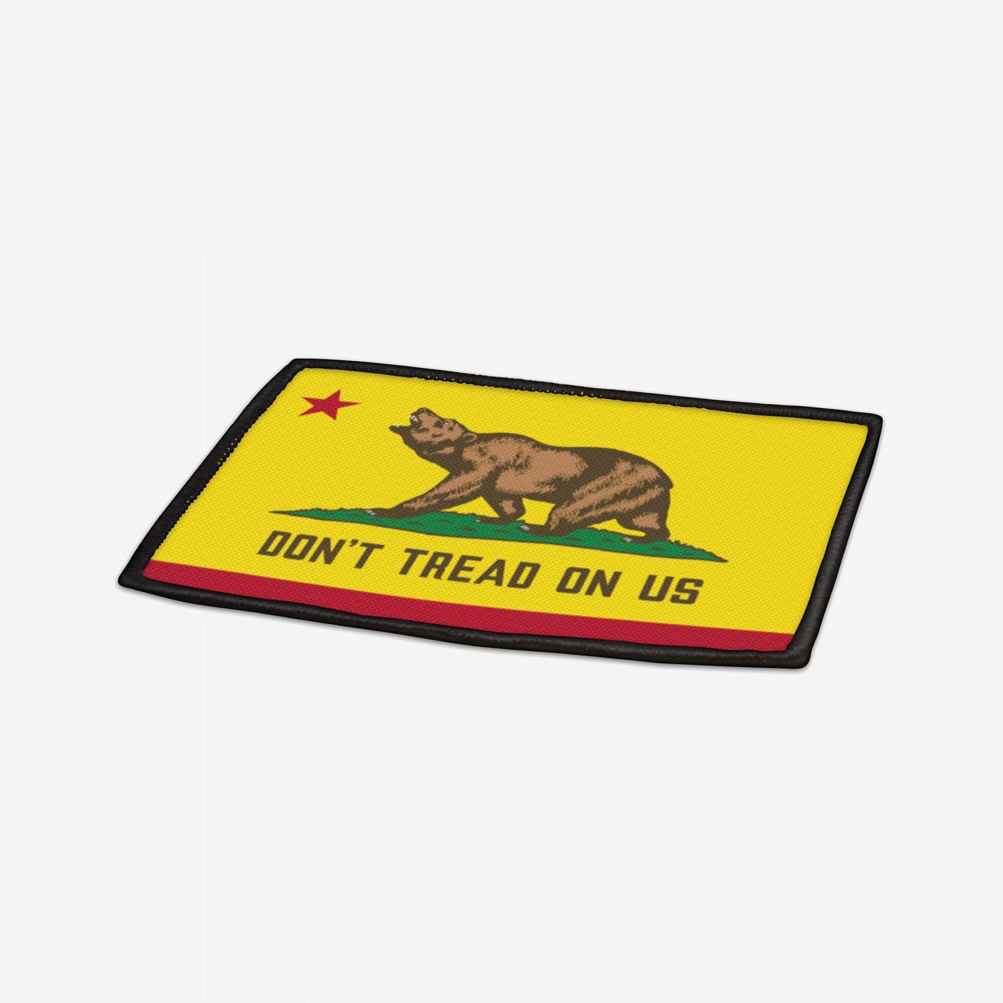 California Gadsden Flag Patch featuring a brown bear and “DON’T TREAD ON US” slogan on a yellow background, designed to symbolize state pride and defiance, with an iron-on backing.