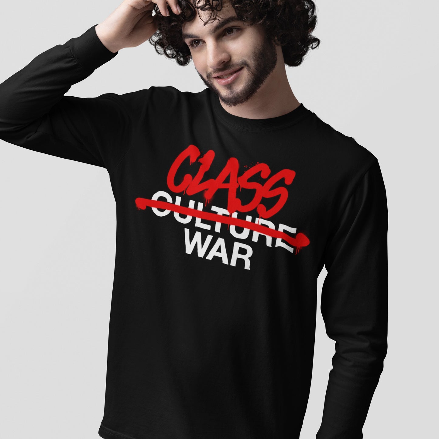 Young man wearing the Class War T-shirt, featuring the word CULTURE crossed out in red and replaced with bold red CLASS, above WAR in white, highlighting the shift from culture to class conflict.