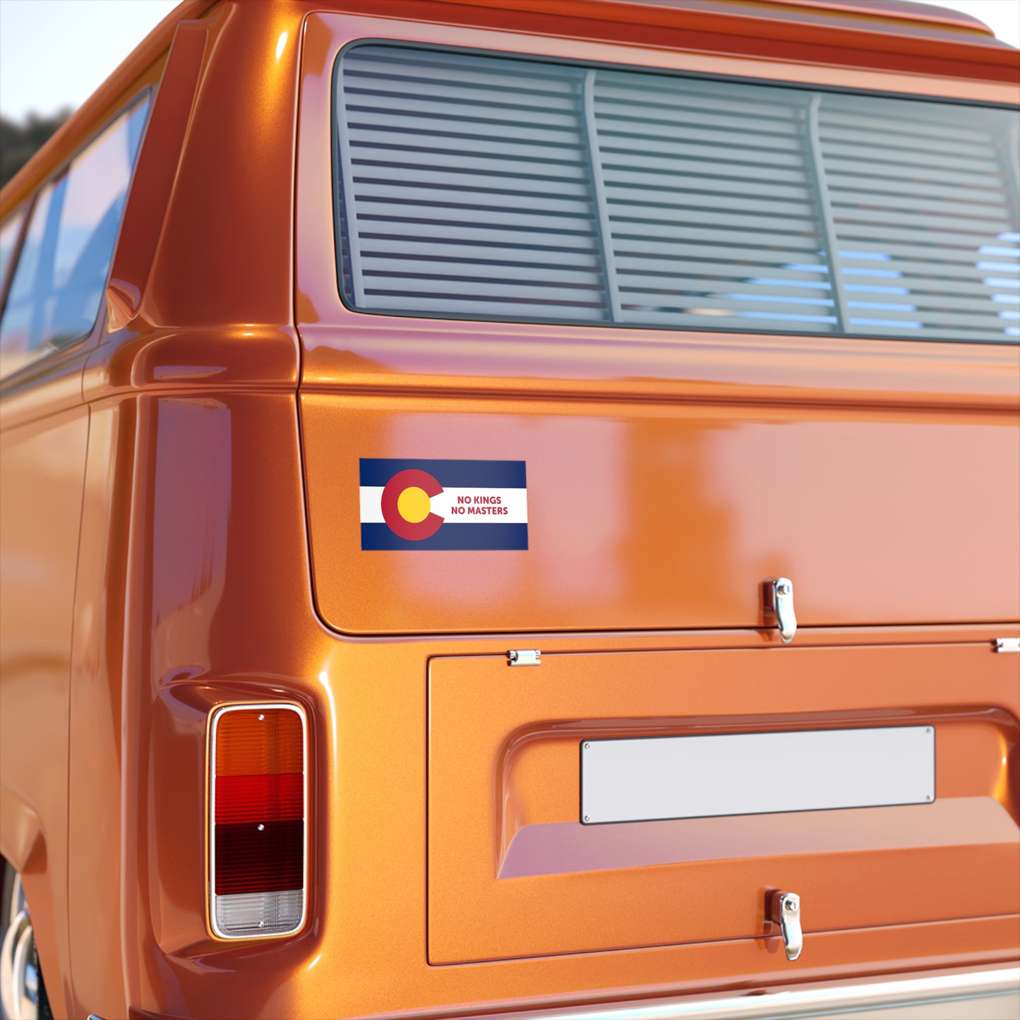 Close-up of an orange vintage van's rear, showcasing the Colorado Flag No Kings Sticker & Magnet, transforming the state flag into a bold statement against control, affixed to the back hatch.