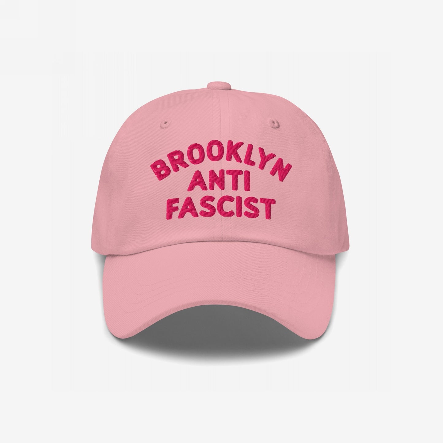 Custom Anti-Fascist Dad Hat featuring BROOKLYN ANTI FASCIST in bold embroidery. This light pink, unstructured cap combines comfort and activism with an adjustable strap and pre-curved visor.