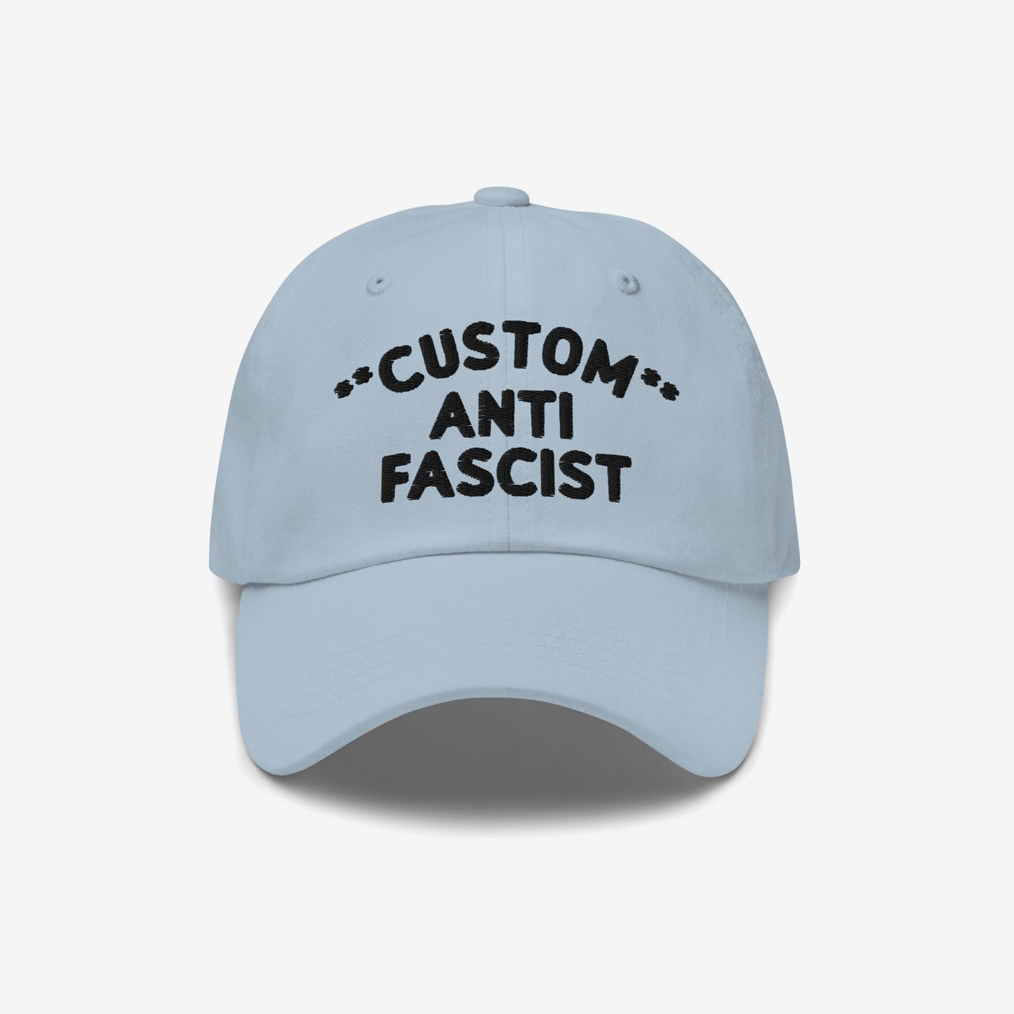 Light-blue Custom Anti-Fascist Dad Hat with black embroidered text. Features unstructured, low-profile design, pre-curved visor, and adjustable strap. Personalize with your message to boldly express anti-fascist values.