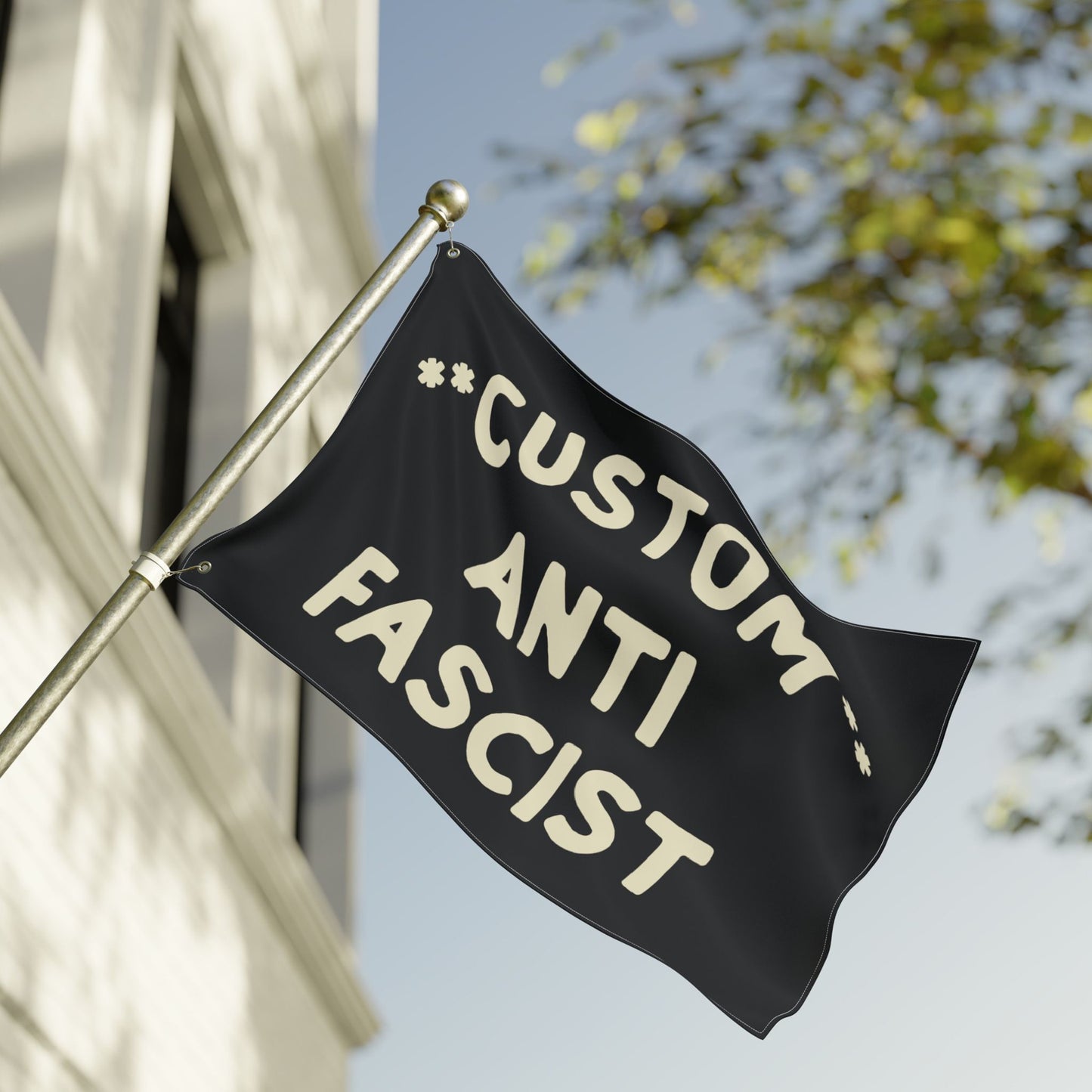 Black Custom Anti-Fascist Flag mounted on a metal pole, featuring bold, off-white text. Ideal for rallies or home, this flag supports anti-fascism with customizable messaging, available in various colors and sizes.