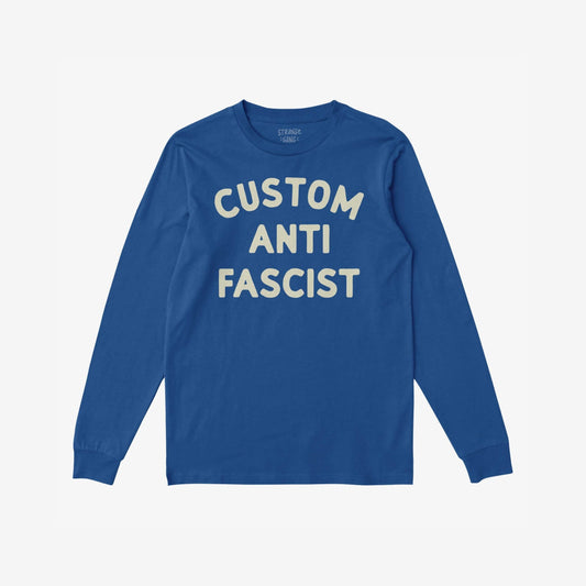 Blue Custom Anti-Fascist Long Sleeve T-shirt with cream CUSTOM ANTI FASCIST block letters across the chest, offering personalization options for activism and casual wear.