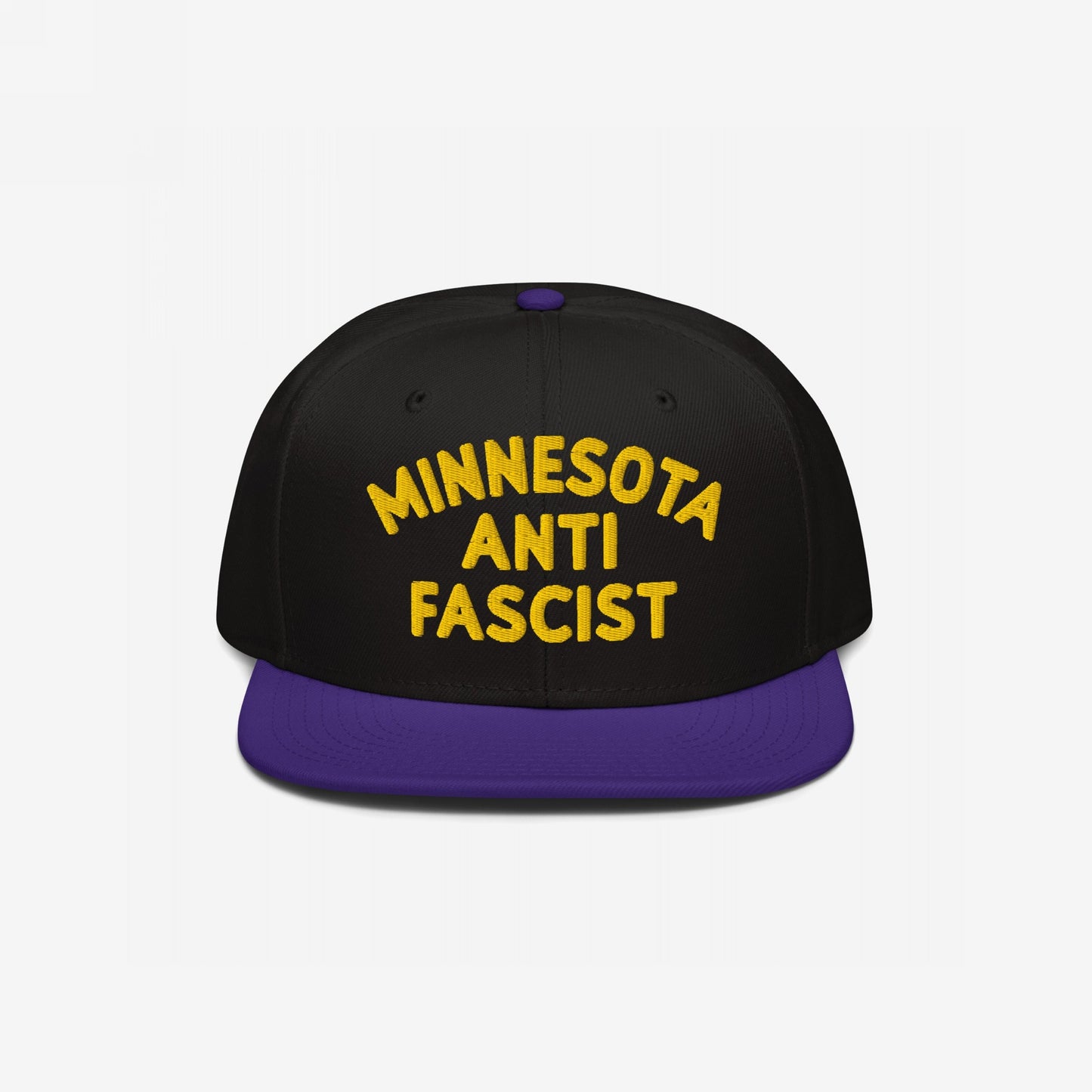 Custom Anti-Fascist Snapback Hat featuring bold yellow MINNESOTA ANTI FASCIST embroidery on the front. Black crown, purple flat brim, adjustable closure, promoting equality and anti-fascism with customizable city or community text.