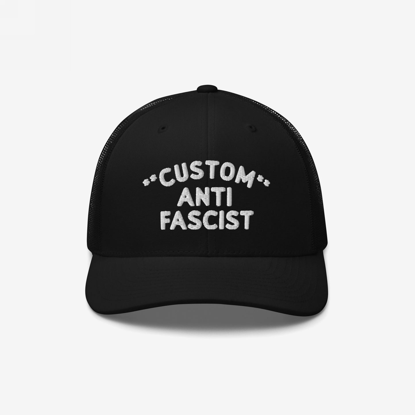 Black mesh-back trucker cap with curved visor, featuring CUSTOM ANTI FASCIST. embroidered in white. Personalize the Custom text. Breathable and adjustable, embodying bold anti-fascist messaging with style and comfort.