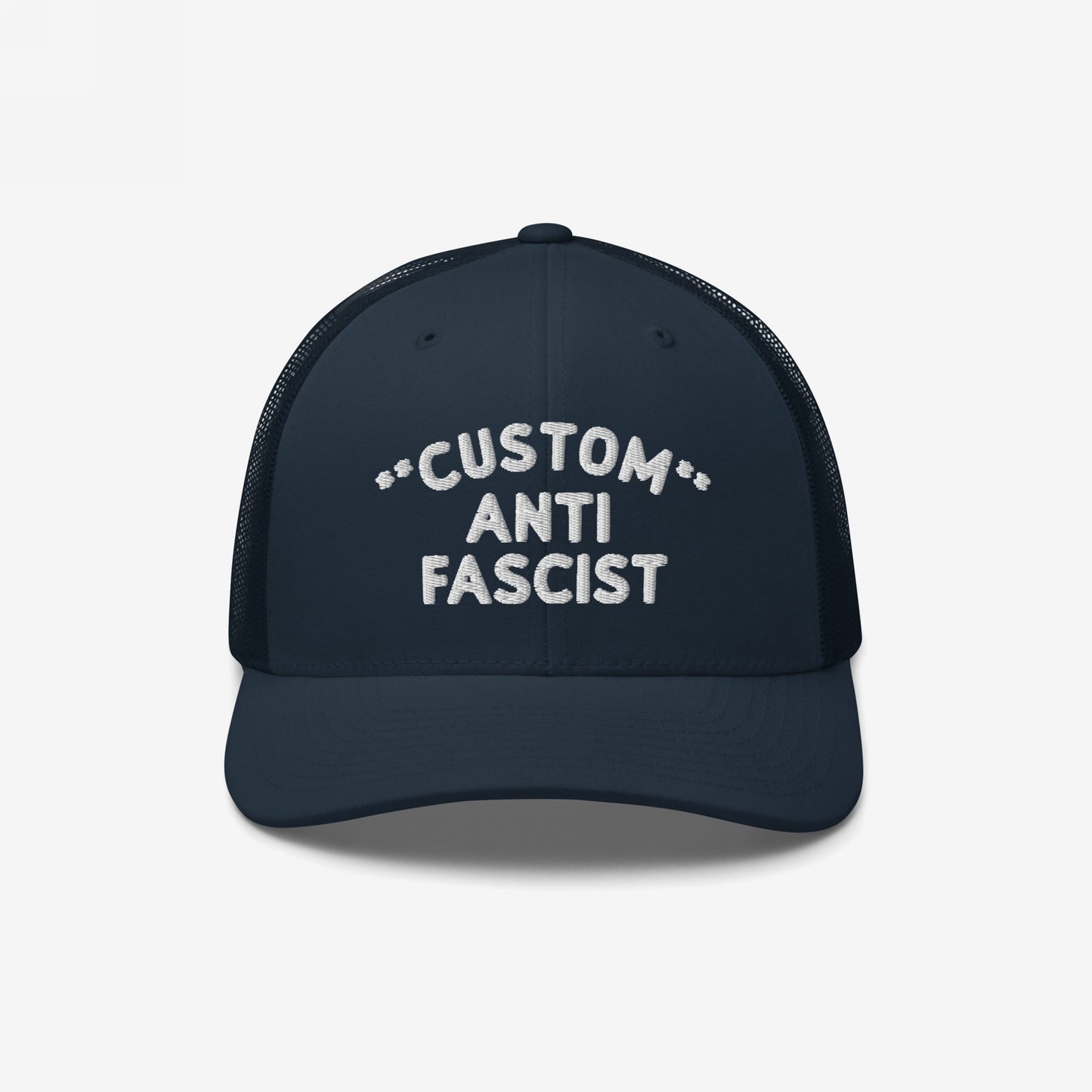 Navy-blue Custom Anti-Fascist Trucker Hat with white embroidered text, featuring a breathable mesh back and adjustable snap closure. Personalize the “Custom” text to reflect your community or beliefs.